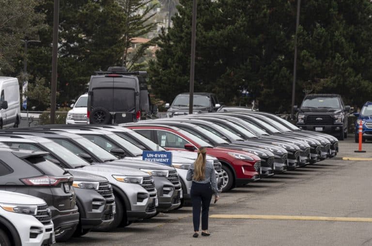 A salesperson walks on the lot of a Ford Motor Co. dealership in Colma, California, U.S., on Wednesday, June 30, 2021. With dwindling inventory over the last three months, U.S. auto sales has taken a sharp turn for the worse. Photographer: David Paul Morris/Bloomberg