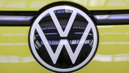 The badge of a Volkswagen ID Buzz electric microbus at the Volkswagen AG (VW) multipurpose and commercial vehicle plant in Hannover, Germany, on Thursday, June 16, 2022. Europe's biggest automaker is set to become the world's biggest electric-car maker, inching past rival Tesla Inc. by 2024, according to Bloomberg Intelligence.