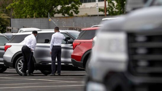 Customers view a vehicle for sale at a Ford Motor Co. dealership in Richmond, California, U.S., on Thursday, July 1, 2021. The global semiconductor shortage that hobbled auto production worldwide this year is leaving showrooms with few models to showcase just as U.S. consumers breaking free of pandemic restrictions are eager for new wheels.