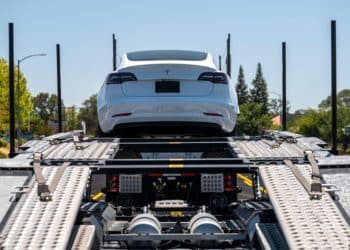 A Tesla Model 3 vehicle on an auto carrier in front of a store in Rocklin, California, U.S., on Wednesday, July 21, 2021. Tesla Inc. is scheduled to release earnings figures on July 26.