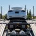 A Tesla Model 3 vehicle on an auto carrier in front of a store in Rocklin, California, U.S., on Wednesday, July 21, 2021. Tesla Inc. is scheduled to release earnings figures on July 26.