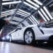 A worker checks a Porsche Taycan on the production line in Stuttgart, Germany. Photographer: Krisztian Bocsi/Bloomberg