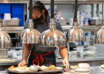 An employee works inside the kitchen at a hotel in New York.