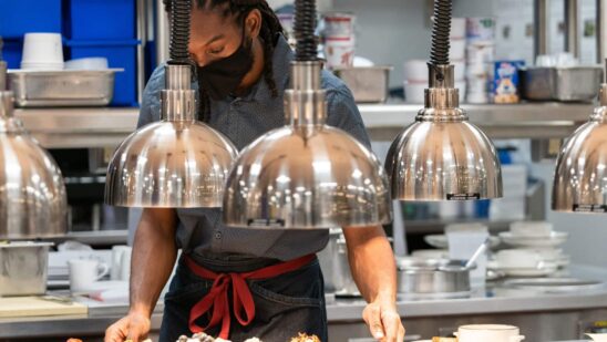 An employee works inside the kitchen at a hotel in New York.