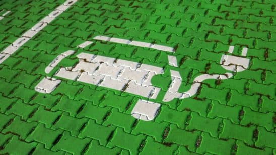 An electric car stencil symbol sits on a parking space at the electric vehicle charging site in Hanover, Germany.