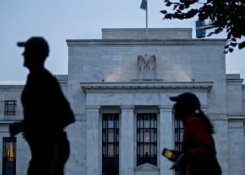 Runners pass the Marriner S. Eccles Federal Reserve building in Washington, D.C., U.S., on Monday, Aug. 13, 2018. Federal Reserve officials left U.S. interest rates unchanged in August and stuck with a plan to gradually lift borrowing costs amid strong growth that backs bets for a hike in September.