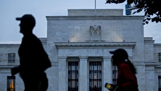 Runners pass the Marriner S. Eccles Federal Reserve building in Washington, D.C., U.S., on Monday, Aug. 13, 2018. Federal Reserve officials left U.S. interest rates unchanged in August and stuck with a plan to gradually lift borrowing costs amid strong growth that backs bets for a hike in September.