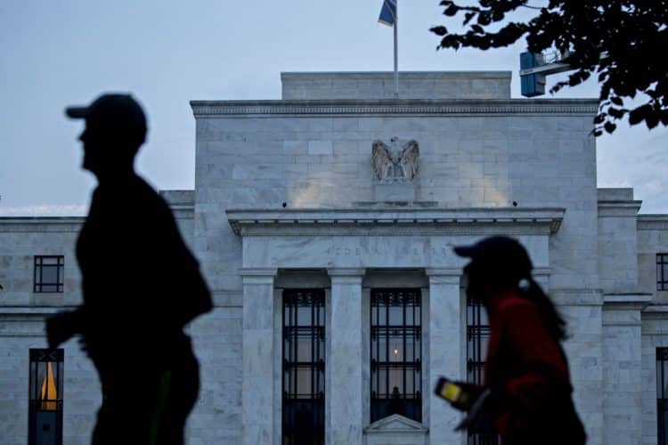 Runners pass the Marriner S. Eccles Federal Reserve building in Washington, D.C., U.S., on Monday, Aug. 13, 2018. Federal Reserve officials left U.S. interest rates unchanged in August and stuck with a plan to gradually lift borrowing costs amid strong growth that backs bets for a hike in September.