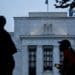 Runners pass the Marriner S. Eccles Federal Reserve building in Washington, D.C., U.S., on Monday, Aug. 13, 2018. Federal Reserve officials left U.S. interest rates unchanged in August and stuck with a plan to gradually lift borrowing costs amid strong growth that backs bets for a hike in September.