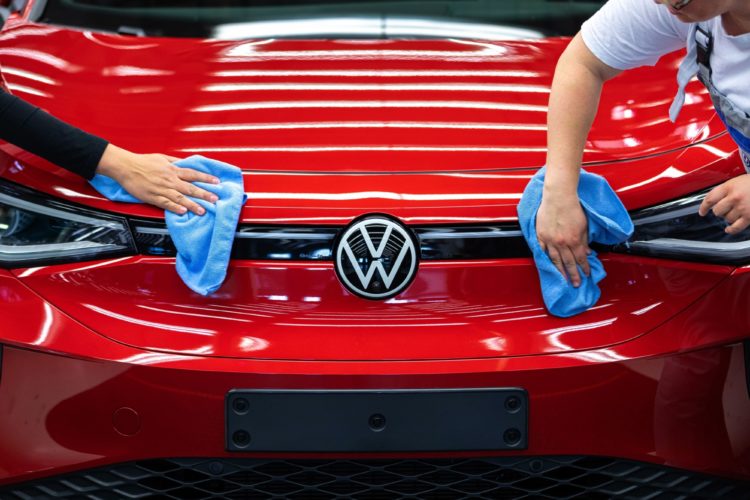 Employee conducts quality control checks on a Volkswagen AG (VW) ID.5 electric sports utility vehicle (eSUV) on the assembly line at the automaker's electric automobile plant in Zwickau, Germany, on Tuesday, April 26, 2022. The Zwickau assembly lines are the centerpiece of a plan by VW, the world's biggest automaker, to manufacture as many as 330,000 cars annually.