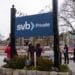 Customers stand waiting in line outside a Silicon Valley Bank branch in Wellesley, Massachusetts, US, on Monday, March 13, 2023. The collapse ofSilicon Valley Bankhas prompted aglobal reckoningat venture capital and private equity firms, which found themselves suddenly exposed all together to the tech industrys money machine.