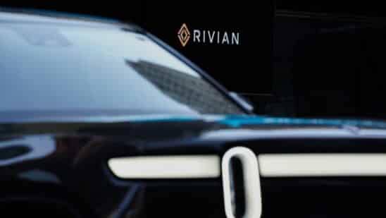 Rivian signage during the company's IPO outside the Nasdaq MarketSite in New York, U.S., on Wednesday, Nov. 10, 2021. Electric vehicle-maker Rivian Automotive Inc. priced shares in its initial public offering at $78 apiece to raise about $11.9 billion, the biggest first-time share sale this year.