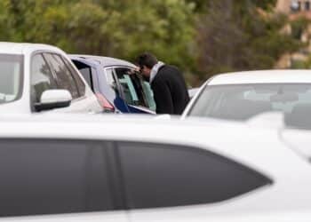 A customer views a vehicle for sale at a car dealership in Richmond, California, U.S., on Thursday, July 1, 2021. The global semiconductor shortage that hobbled auto production worldwide this year is leaving showrooms with few models to showcase just as U.S. consumers breaking free of pandemic restrictions are eager for new wheels.