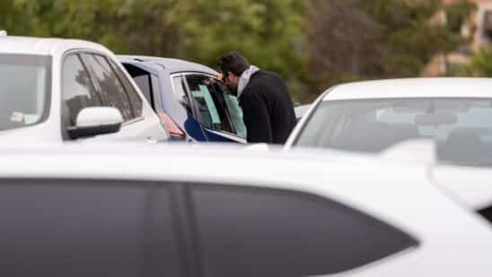 A customer views a vehicle for sale at a car dealership in Richmond, California, U.S., on Thursday, July 1, 2021. The global semiconductor shortage that hobbled auto production worldwide this year is leaving showrooms with few models to showcase just as U.S. consumers breaking free of pandemic restrictions are eager for new wheels.