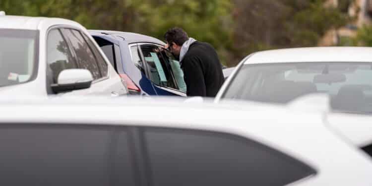 A customer views a vehicle for sale at a car dealership in Richmond, California, U.S., on Thursday, July 1, 2021. The global semiconductor shortage that hobbled auto production worldwide this year is leaving showrooms with few models to showcase just as U.S. consumers breaking free of pandemic restrictions are eager for new wheels.