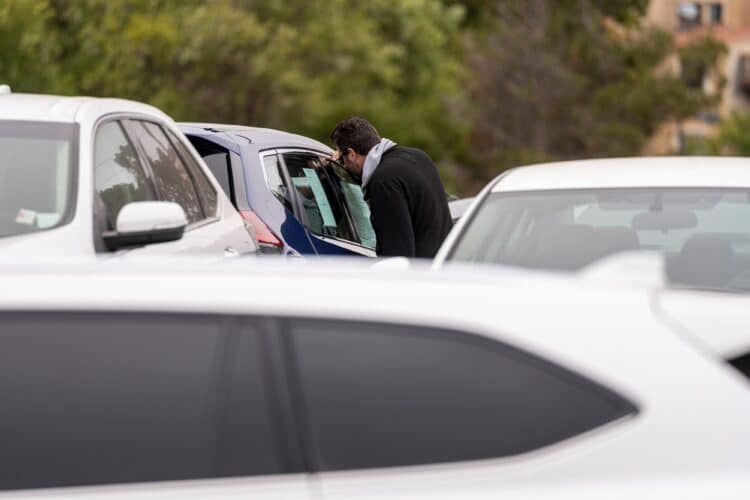 A customer views a vehicle for sale at a car dealership in Richmond, California, U.S., on Thursday, July 1, 2021. The global semiconductor shortage that hobbled auto production worldwide this year is leaving showrooms with few models to showcase just as U.S. consumers breaking free of pandemic restrictions are eager for new wheels.