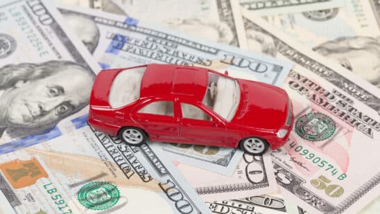 Toy car sitting on money