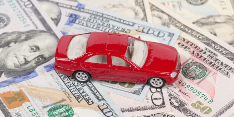Toy car sitting on money