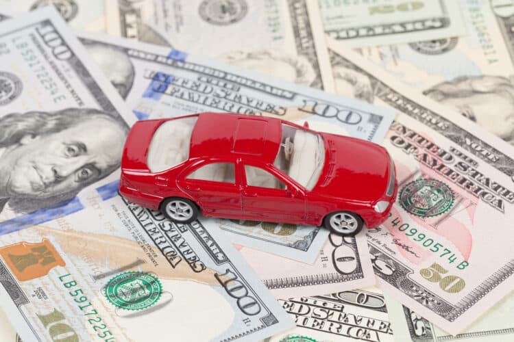 Toy car sitting on money