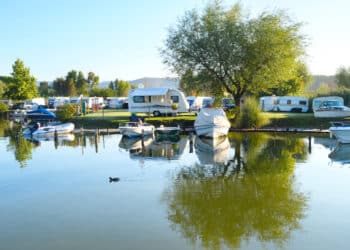 RVs and marine vehicles at an outdoor recreational area.