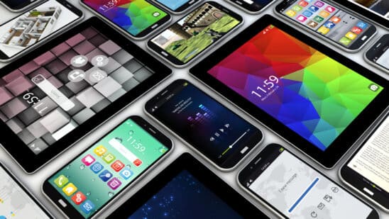 Smart phones and tablets laid out on a table