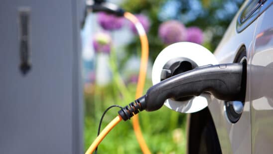 Close up of a charger plugged into an electric vehicle