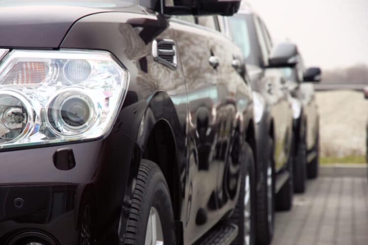 Close up of the headlight of a black SUV