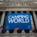 Camping World Holdings Inc. signage is displayed as American Flags fly outside of the New York Stock Exchange (NYSE) during the company's initial public offering (IPO) in New York, U.S., on Friday, Oct. 7, 2016. U.S. stocks fell after jobs data showing steady growth in the labor market likely kept the Federal Reserve on track to tighten monetary policy this year as investors turn to the third-quarter earnings season.