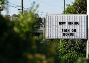 A sign that says now hiring