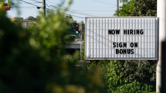 A sign that says now hiring