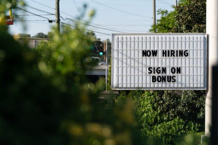 A sign that says now hiring