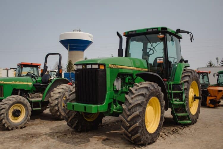 John Deere tractors in a lot during a Ritchie Bros heavy equipment auction in Bolton, Ontario, Canada, on Tuesday, May 9, 2023. Ritchie Bros Auctioneers Inc., a Canadian firm that sells heavy equipment at auctions around North America, struck an agreement in November to buy IAA, which sells damaged and written-off vehicles. Photographer: Chloe Ellingson/Bloomberg