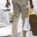 A pedestrian carries shopping bags in the SoHo neighborhood of New York, US on Wednesday, March 22, 2023. US retail sales fell in February after a surge in the prior month, suggesting consumer spending, while holding up, is getting challenged by high inflation.