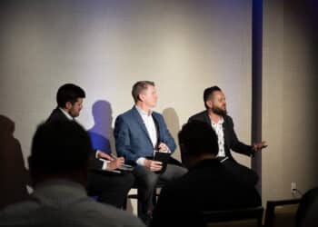 Landon Starr, Chief Risk and Information Officer at Arivo Acceptance (R), sits with Mark Cromer, Chief Operations and Technology Officer at Farm Bureau Bank (middle), and Riley Wolfbauer of Auto Finance News (L) for a panel discussion Auto Finance Summit East.