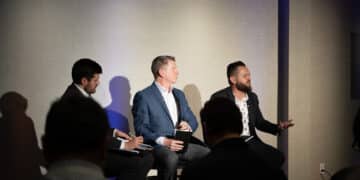 Landon Starr, Chief Risk and Information Officer at Arivo Acceptance (R), sits with Mark Cromer, Chief Operations and Technology Officer at Farm Bureau Bank (middle), and Riley Wolfbauer of Auto Finance News (L) for a panel discussion Auto Finance Summit East.
