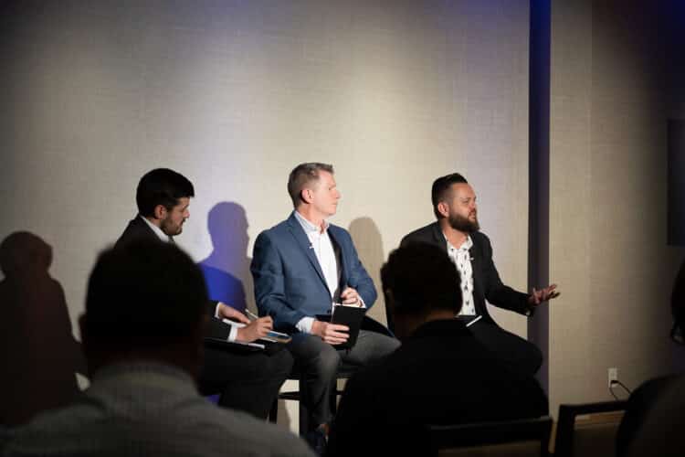 Landon Starr, Chief Risk and Information Officer at Arivo Acceptance (R), sits with Mark Cromer, Chief Operations and Technology Officer at Farm Bureau Bank (middle), and Riley Wolfbauer of Auto Finance News (L) for a panel discussion Auto Finance Summit East.
