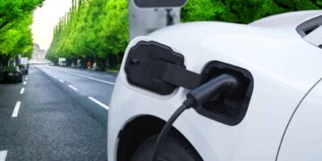 Green city green trees background with electric vehicle