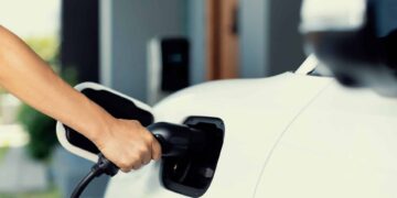 Hand insert an emission-free power connector to the battery of electric vehicle at home