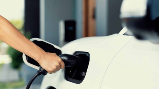 Hand insert an emission-free power connector to the battery of electric vehicle at home