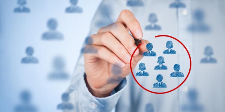 Hand circling silhouettes in red marker