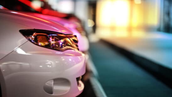 Side profile of the front of a car parked at night