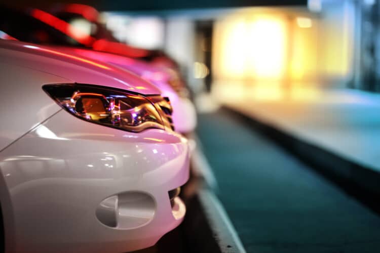 Side profile of the front of a car parked at night