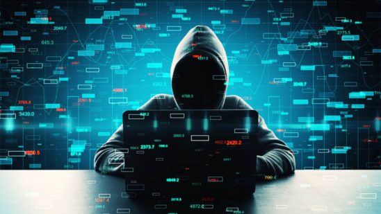 Hacker using computer with forex candlestick charts