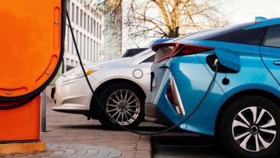 Electric charging station for electric vehicles plugged into cars