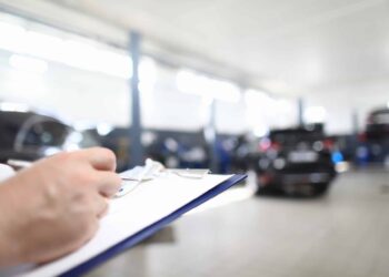 Car dealer places order in car dealership.