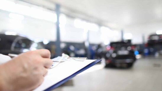 Car dealer places order in car dealership.