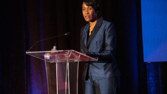 Virnitia Dixon stands at the podium at Auto Finance Summit East