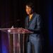 Virnitia Dixon stands at the podium at Auto Finance Summit East