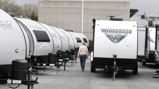 A Winnebago Industries Inc. travel trailer stands at Motor Sportsland RV dealership in Salt Lake City, Utah, U.S., on Monday, April 6, 2020. Amid the coronvirus, government agencies are obtaining RVs to house the homeless and provide housing for medical workers who can not return home in fear of spreading the virus.