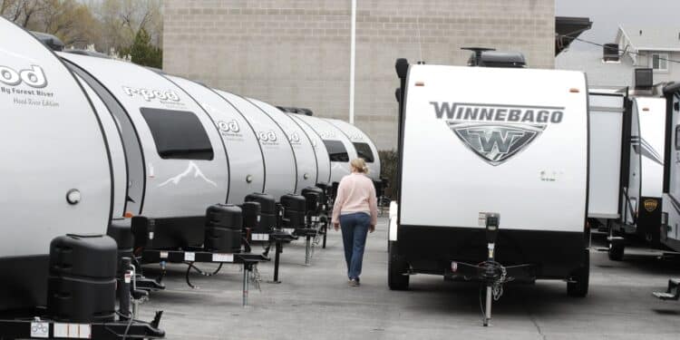 A Winnebago Industries Inc. travel trailer stands at Motor Sportsland RV dealership in Salt Lake City, Utah, U.S., on Monday, April 6, 2020. Amid the coronvirus, government agencies are obtaining RVs to house the homeless and provide housing for medical workers who can not return home in fear of spreading the virus.
